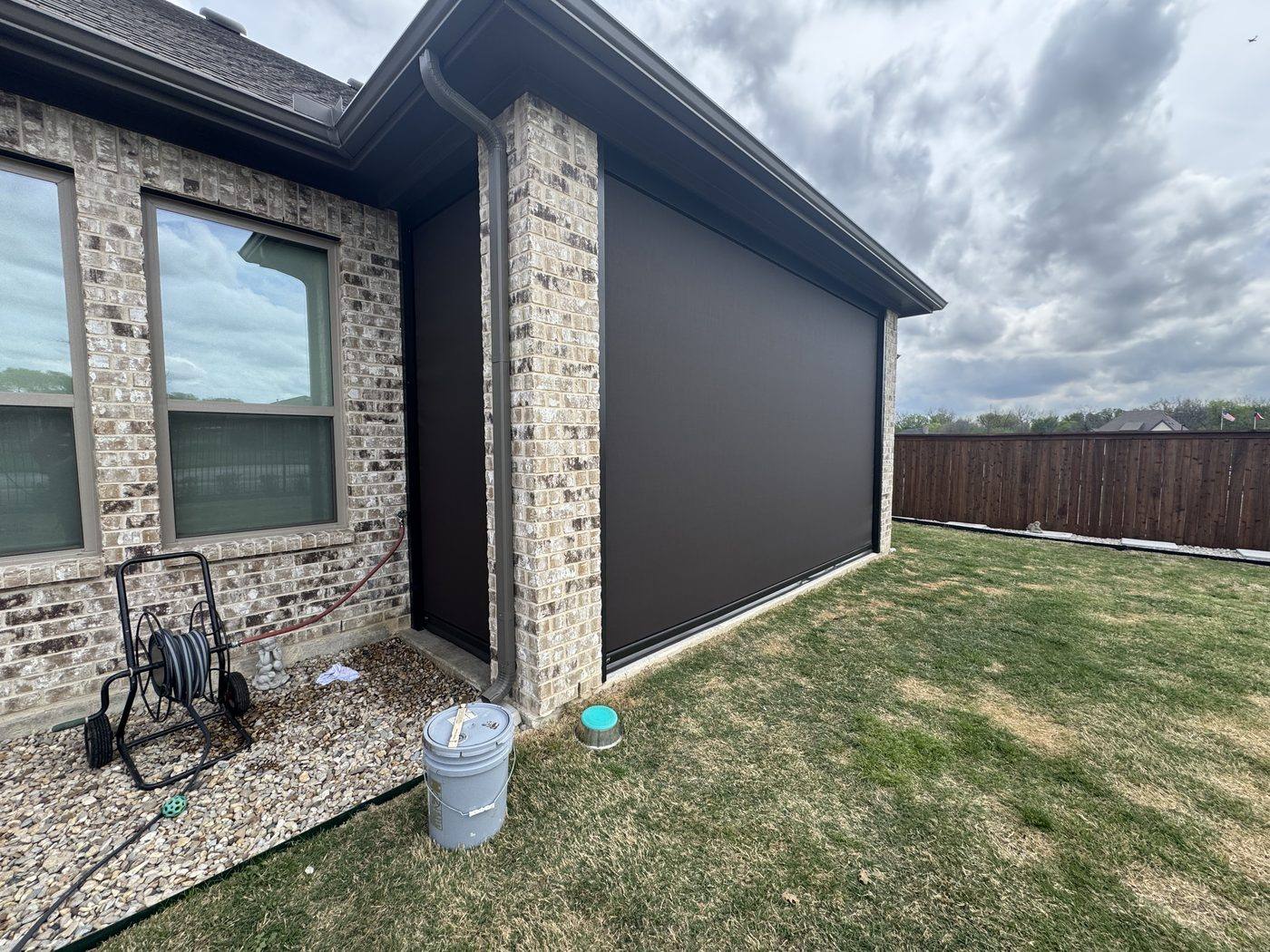 Charcoal screen on brick home