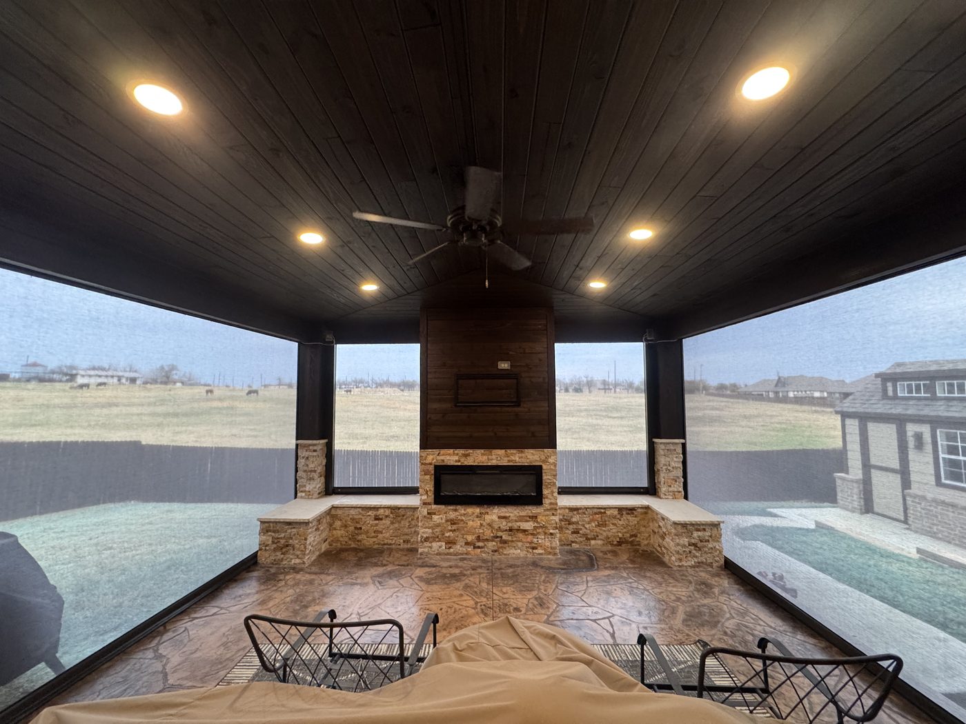 Screened outdoor living room with fireplace